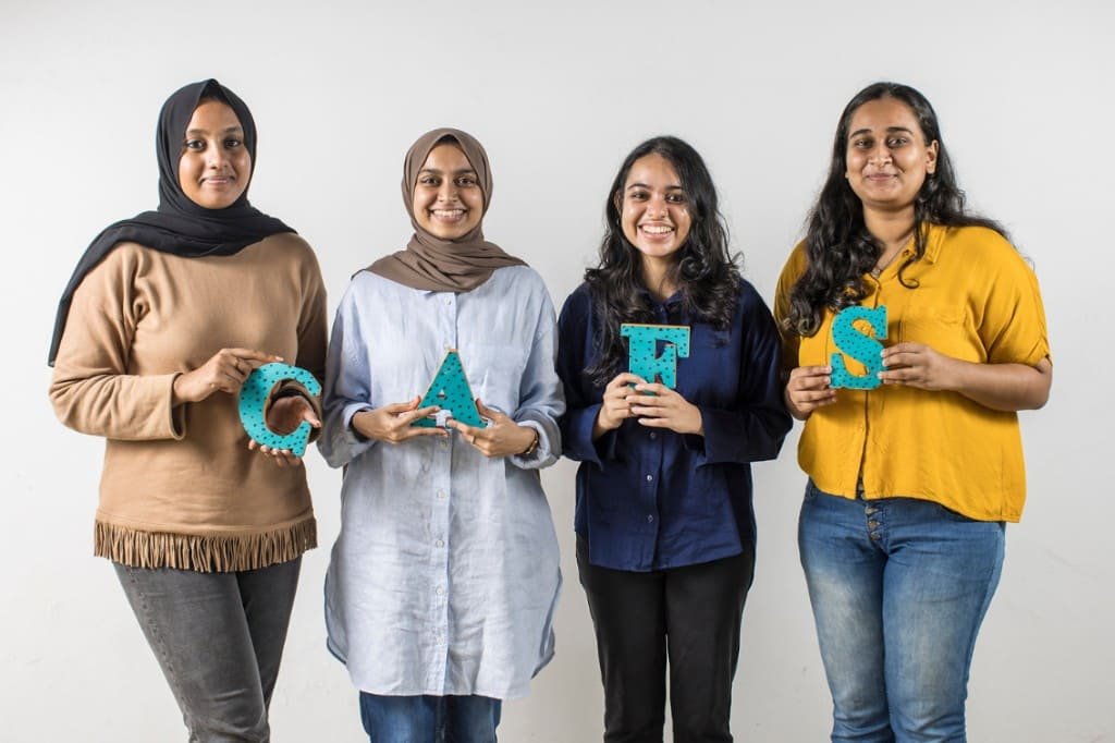 Four team members holding letters that spell CAFS